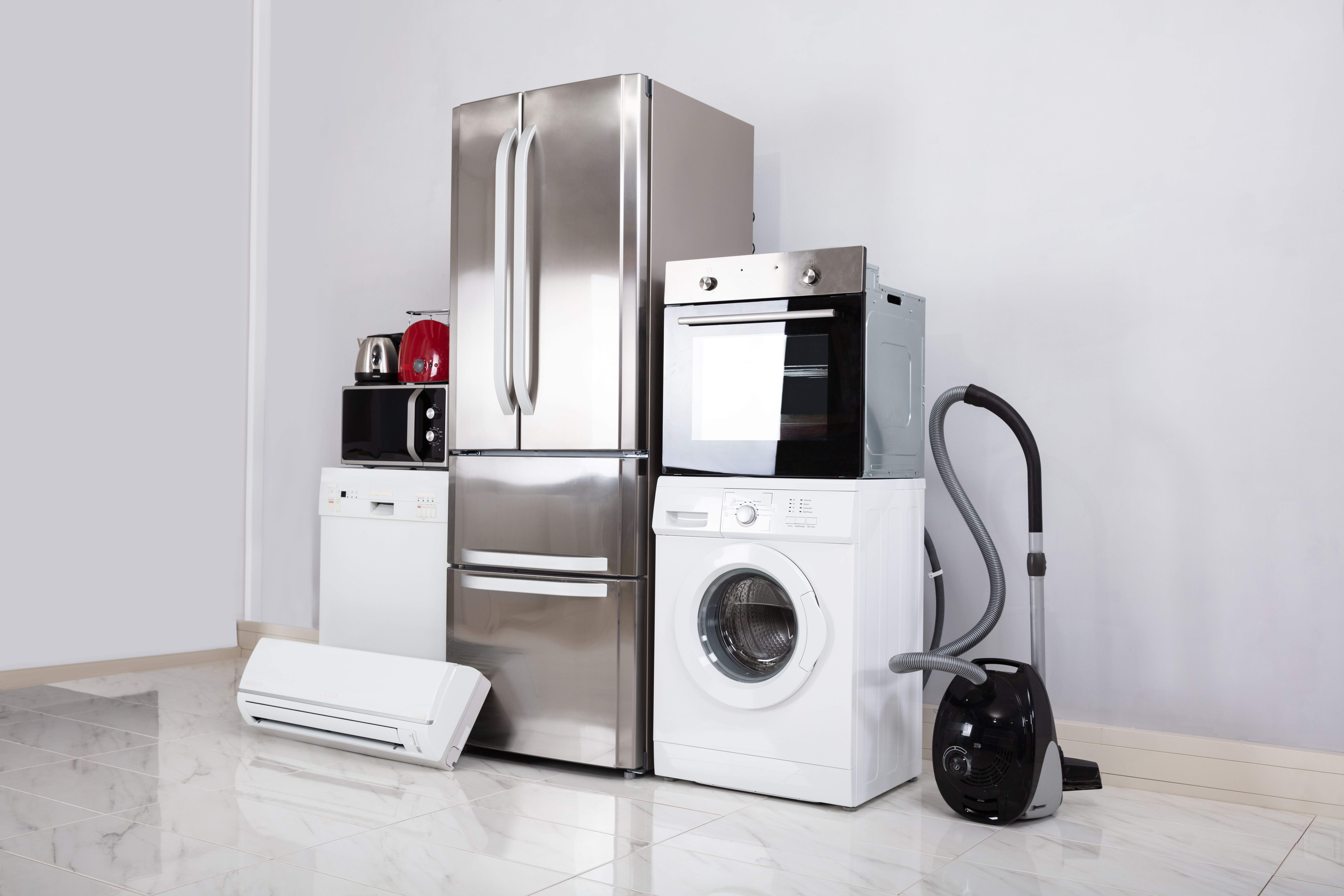 Several consumer products created with precision machined components. Machines on display together including refrigerator, washing machine, drying machine, and vacuum.